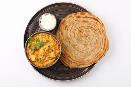 Malabar parotta with Kurma is a delicacy from the state of Kerala, Tamilnadu. Kurma is mixed veg south Indian curry with coconut milk