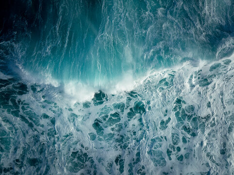 Top down aerial view of moody blue ocean wave
