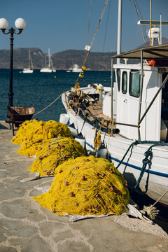 Bright yellow fishing nets by the harbor in Milos