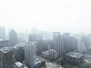 Obraz premium Drone flight in the downtown city skyline, foggy daytime view of Montreal, Quebec, Canada