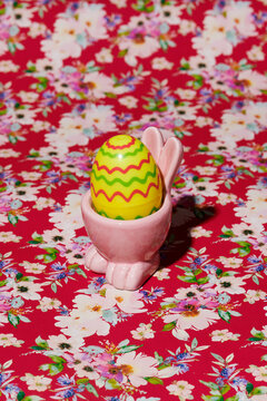 easter egg in a pink rabbit-shaped egg cup