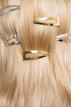 Close-Up of Blonde Hair with Gold and Silver Hair Clips