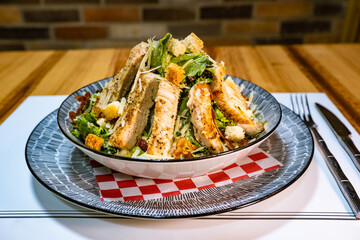 Caesar salad with chicken served on a plate