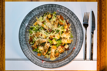 Caesar salad with chicken served on a plate