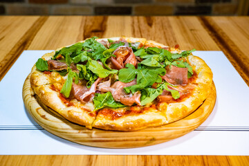 Serrano ham and arugula pizza