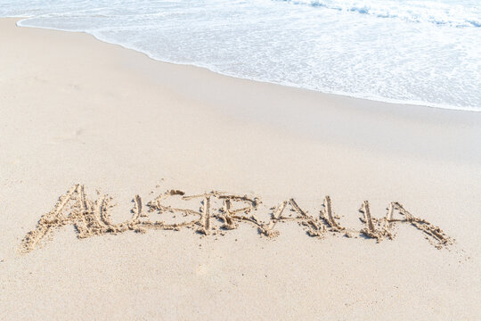 The word Australia written in the white beach sand - Powered by Adobe