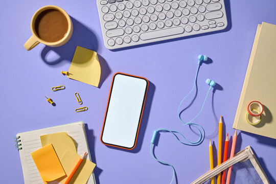 Office workspace with blank screen smartphone and office supplies