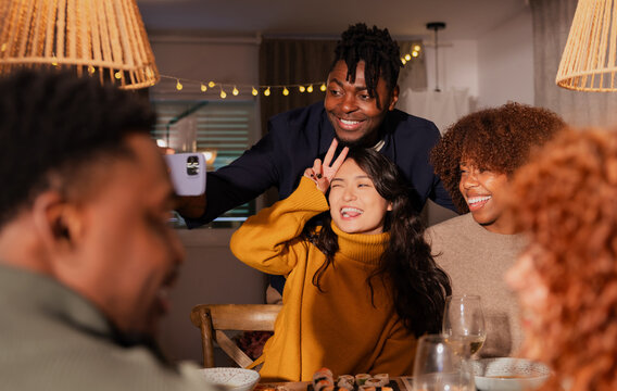 Friends enjoying dinner and taking a selfie together - Powered by Adobe