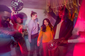 Group celebrating at a vibrant party with balloons