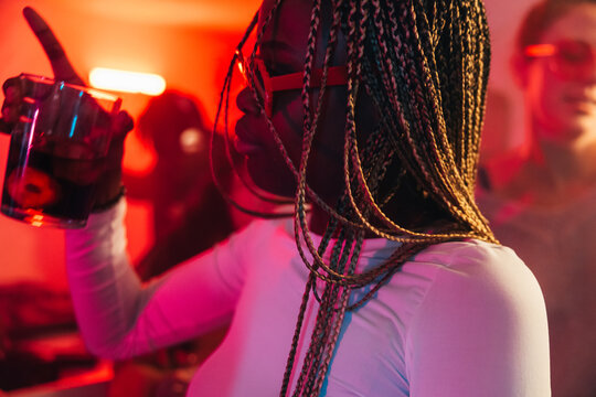 Woman enjoying a vibrant night out at a party