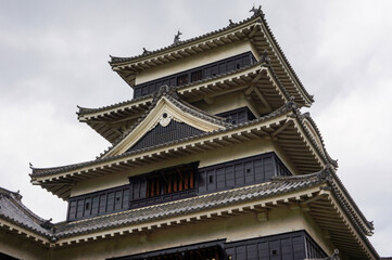 Matsumoto Castle, Japan: An architectural marvel, Matsumoto Castle stands proudly against a cloudy sky, capturing the essence of history and cultural heritage.