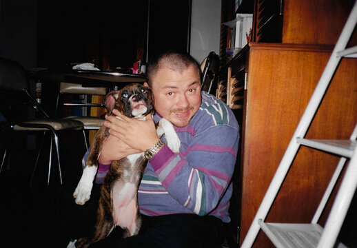Happy man spending quality time with his boxer dog