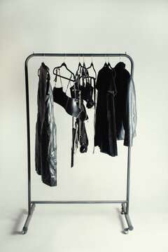 Black gothic clothing rack with velvet, vinyl, and leather textures 