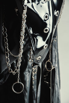 Closeup of black gothic vinyl bodysuit with chains 