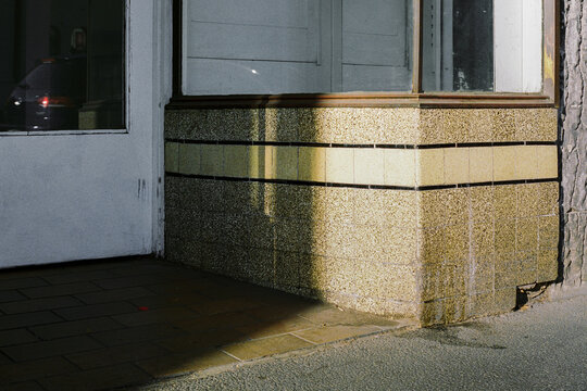 Sunlit corner with subtle texture and reflections In Melbourne