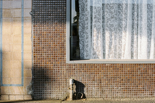 Vintage tiled wall with lace curtain detail