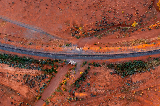Railway tracks over a culvert in red desert landscape