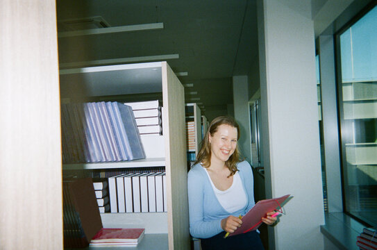 Candid Image Of Happy Student Portrait in Library

