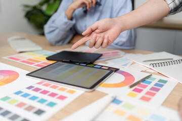 UX and UI Design Collaboration. Creative team discussing color palettes and design elements.
