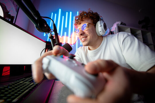 Closeup of a gamer playing intense video game on gaming controller