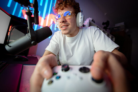 Closeup of a gamer playing intense video game on gaming controller