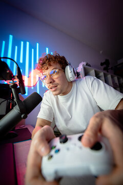 Closeup of a gamer playing intense video game on gaming controller