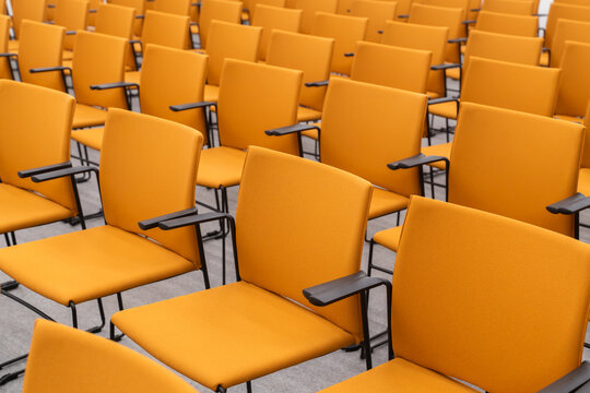 Close Up Of Empty Orange Color Chairs In Rows