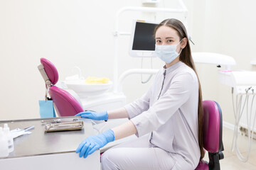 Portrait of female dentist. She's standing in her dentist office.