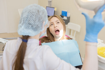 The dentist examines the patient's oral cavity. teeth
