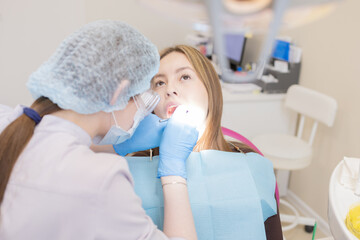 The dentist examines the patient's oral cavity. teeth
