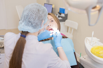 The dentist examines the patient's oral cavity. teeth
