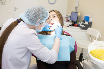 The dentist examines the patient's oral cavity. teeth