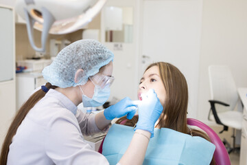 The dentist examines the patient's oral cavity. teeth