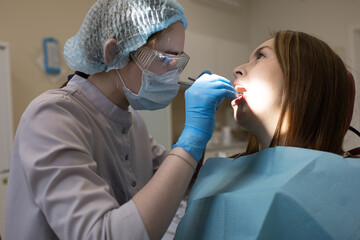 The dentist examines the patient's oral cavity. teeth