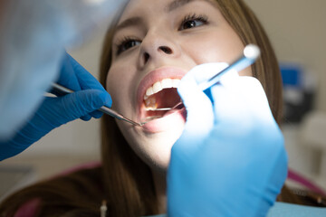 The dentist examines the patient's oral cavity. teeth