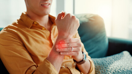 Home, wrist pain and man on couch, hands or inflammation with stress, arthritis or pressure. Red...
