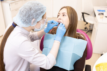 The dentist examines the patient's oral cavity. teeth