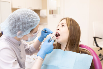 The dentist examines the patient's oral cavity. teeth