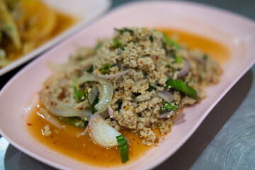 Lab Moo or Larb Moo, Chopped pork mix with Thai spicy curry. Served on plate.