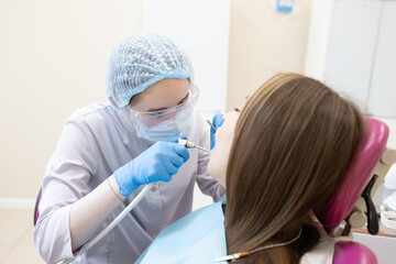 The dentist examines the patient's oral cavity. teeth