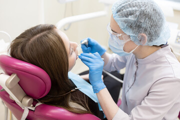 The dentist examines the patient's oral cavity. teeth