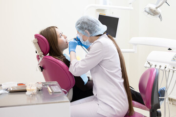 The dentist examines the patient's oral cavity. teeth