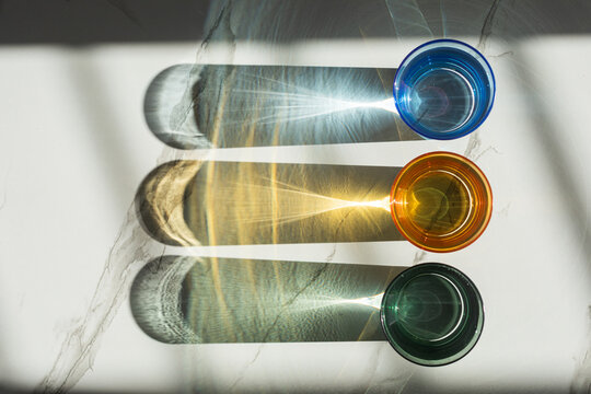 Artistic view of glasses casting colorful shadows