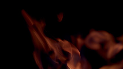 The captivating and mesmerizing flames are dancing gracefully in the surrounding darkness