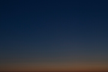 Orange and dark blue cloudless sky in the evening. Abstract natural landscape and background with copy space.