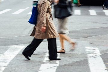Urban Pedestrians Crossing a Busy City Street on a Crosswalk
