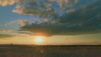 Obraz premium A Breathtaking Stunning Sunset Over a Serene Landscape Surrounded by Colorful Beautiful Skies