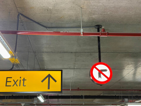 Exit Sign and No Right Turn Symbol in Parking Garage