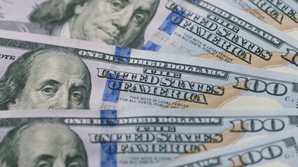 A closeup view of American Hundred Dollar Bills showing their intricate design features