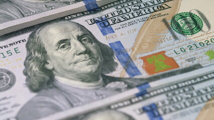 A stack of hundred dollar bills evokes wealth and signals investment opportunities in markets